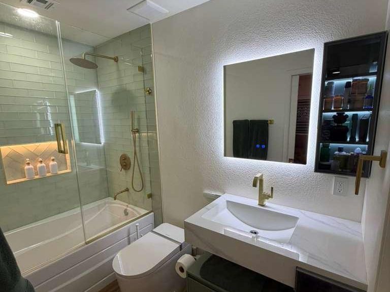 Floating vanity and frameless glass shower in a remodelled bathroom